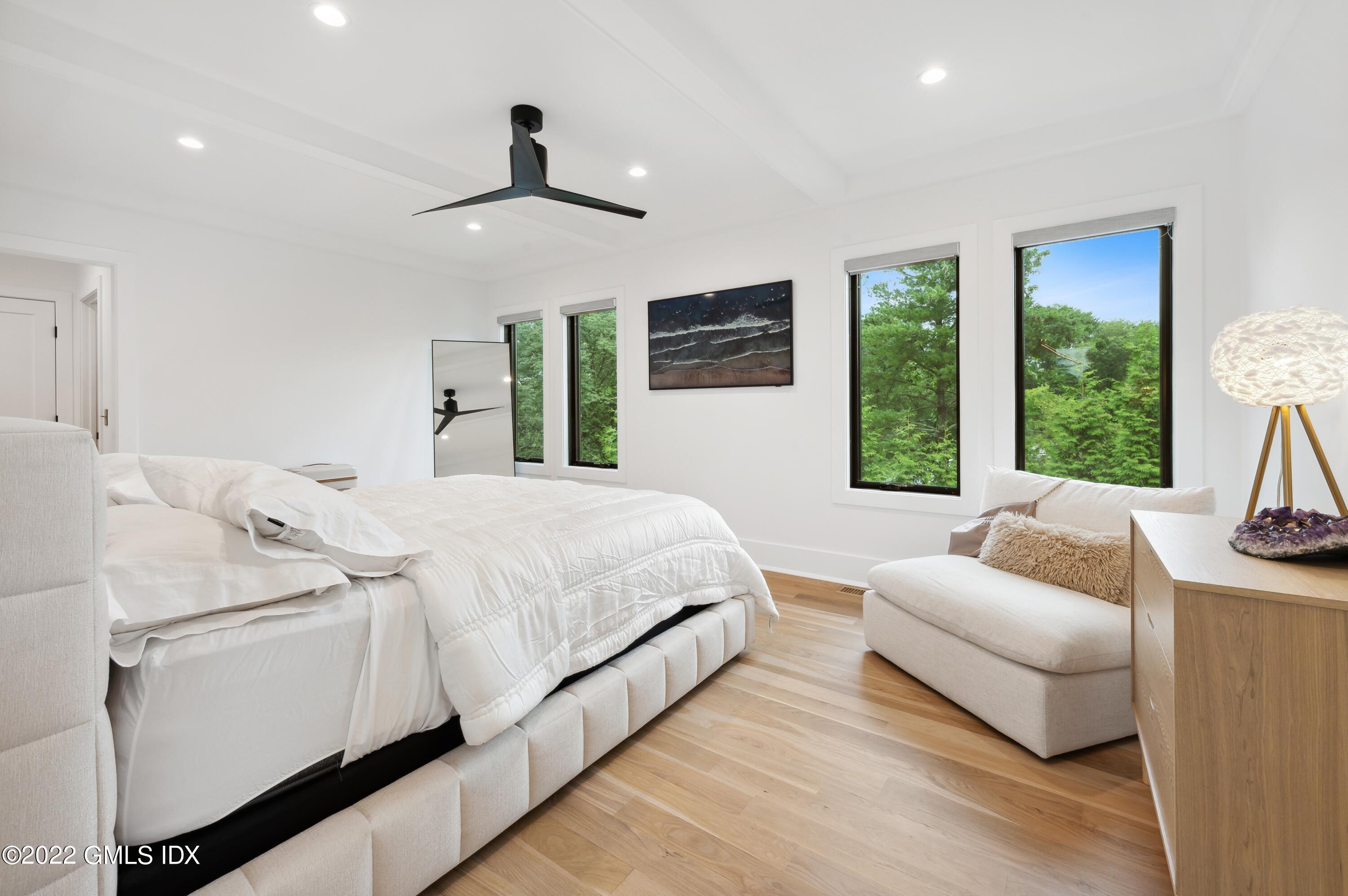 7 Drumlin Road Westport, CT 06880 - Photo 12 of 32 a bedroom with a bed flat screen tv and a large window