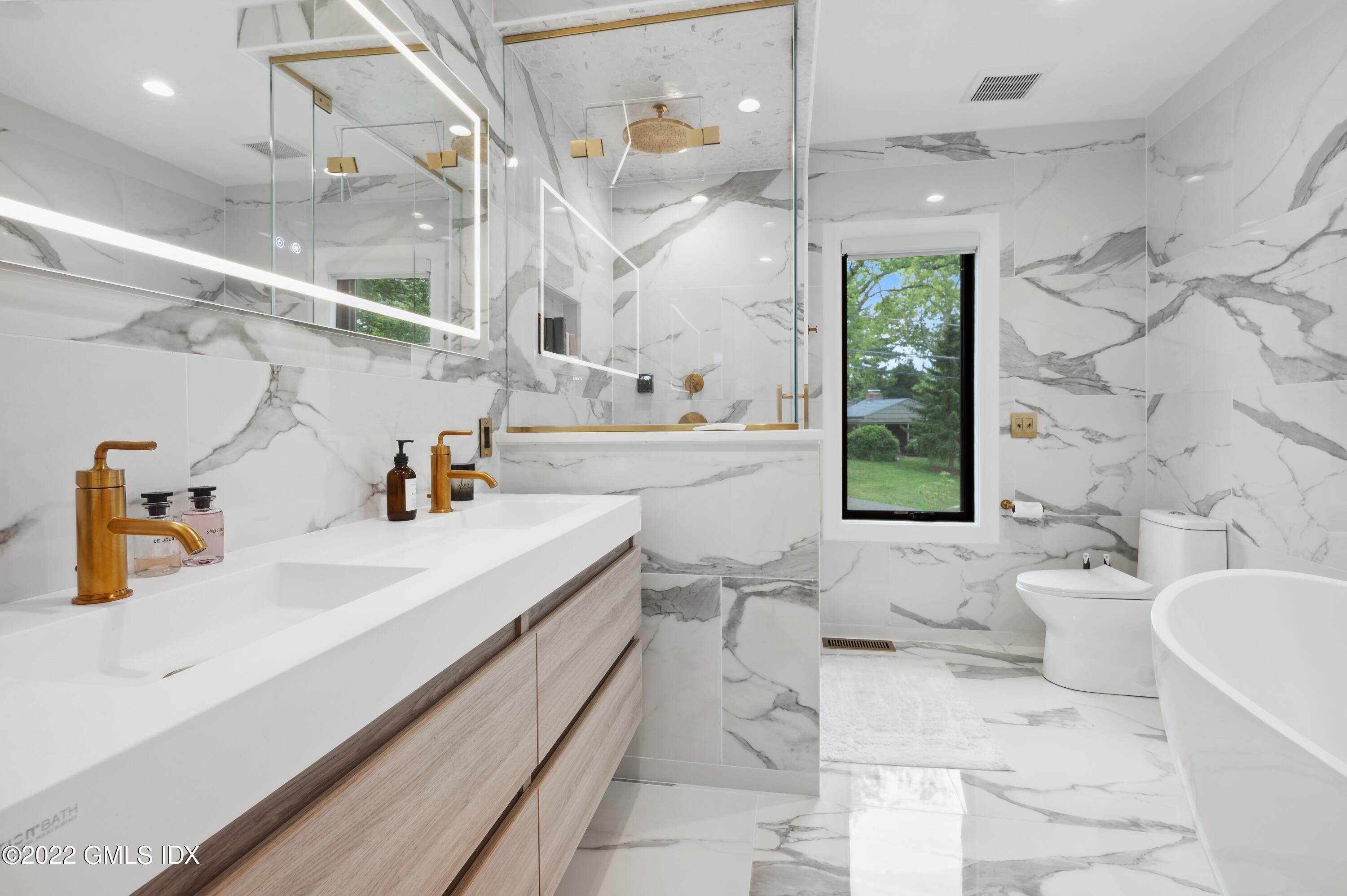 7 Drumlin Road Westport, CT 06880 - Photo 13 of 32 a bathroom with a sink a toilet and shower