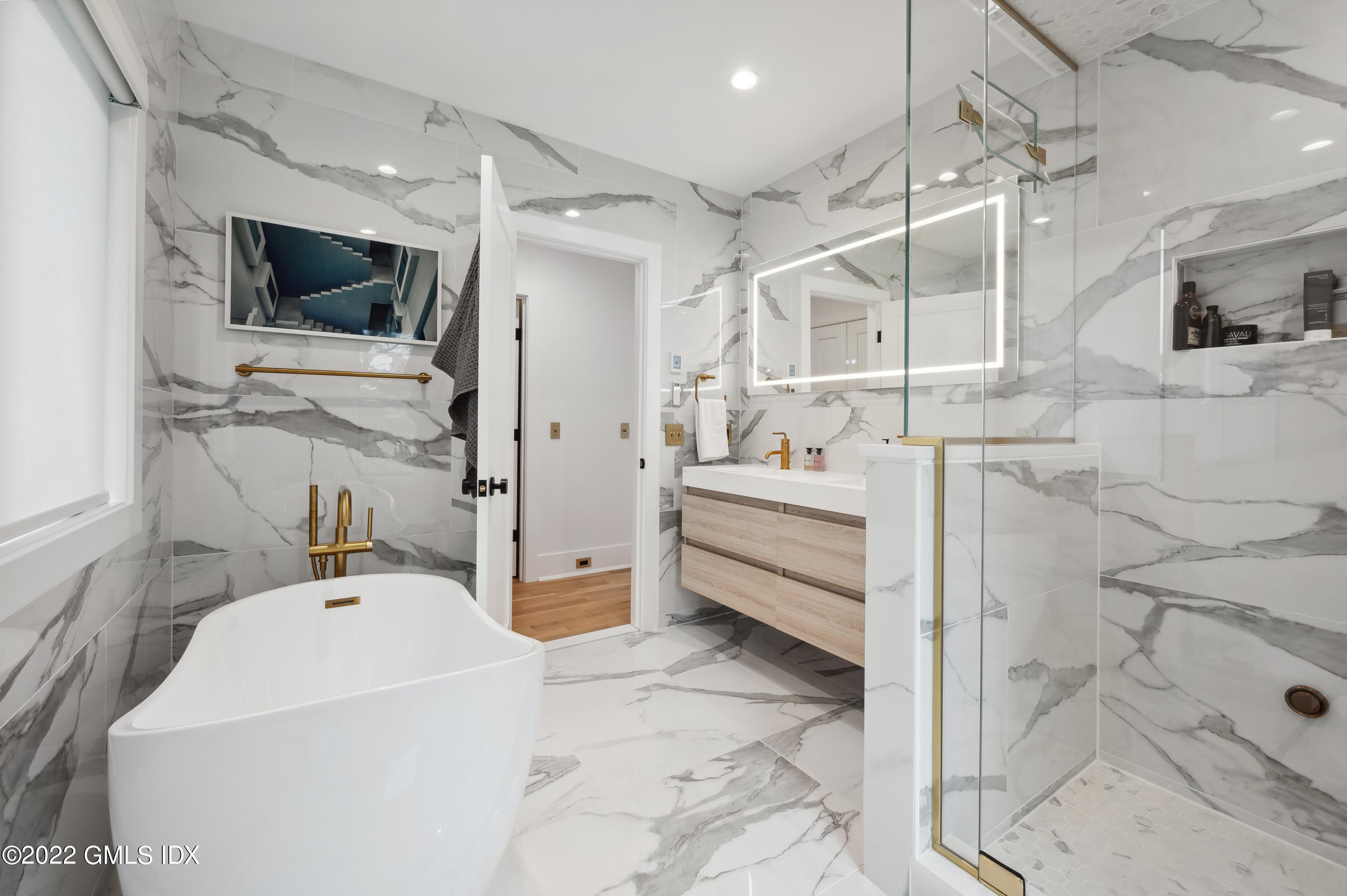 7 Drumlin Road Westport, CT 06880 - Photo 14 of 32 a en suite spacious bathroom with a double vanity sink a mirror and shower