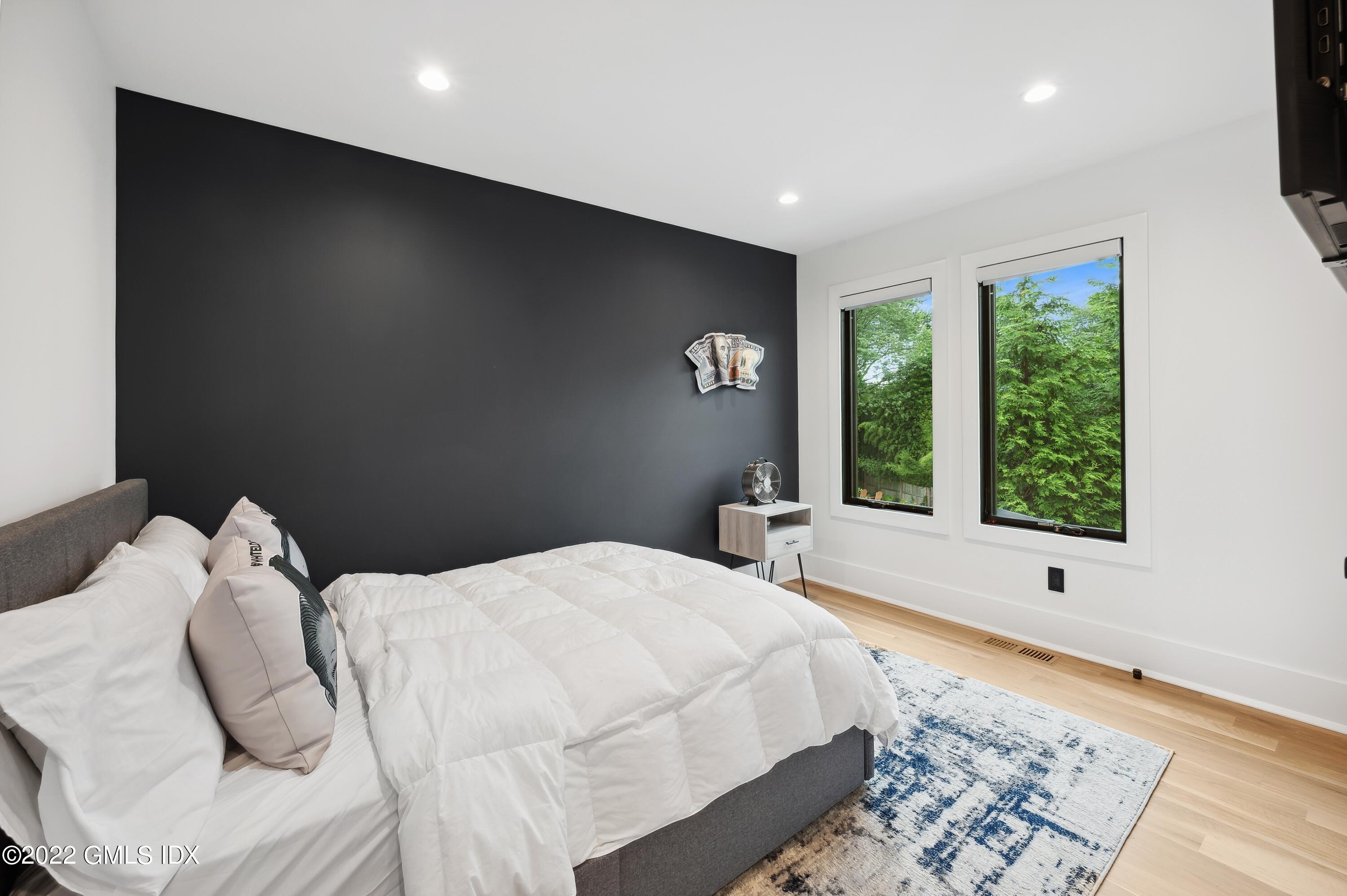 7 Drumlin Road Westport, CT 06880 - Photo 15 of 32 a large bed sitting in a bedroom next to a window