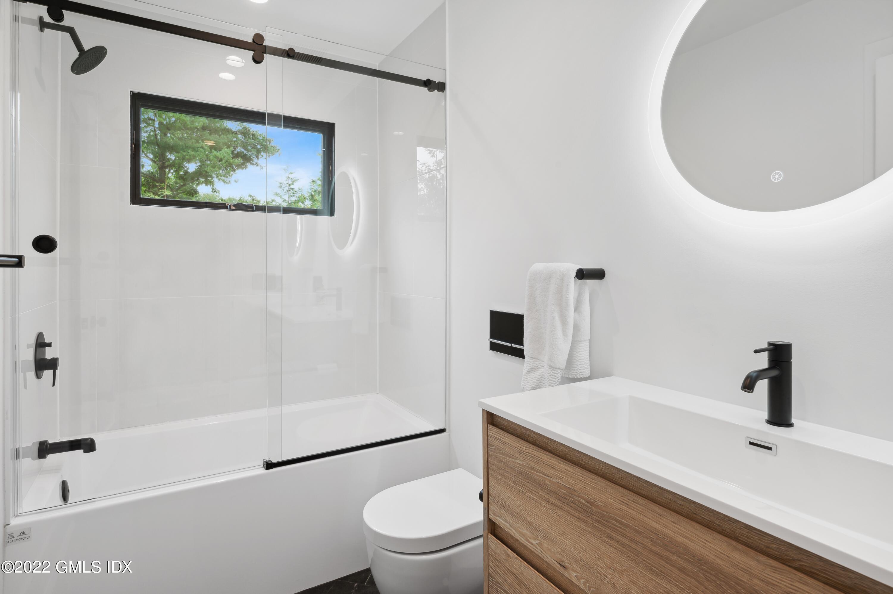 7 Drumlin Road Westport, CT 06880 - Photo 16 of 32 a bathroom with a sink a toilet and shower