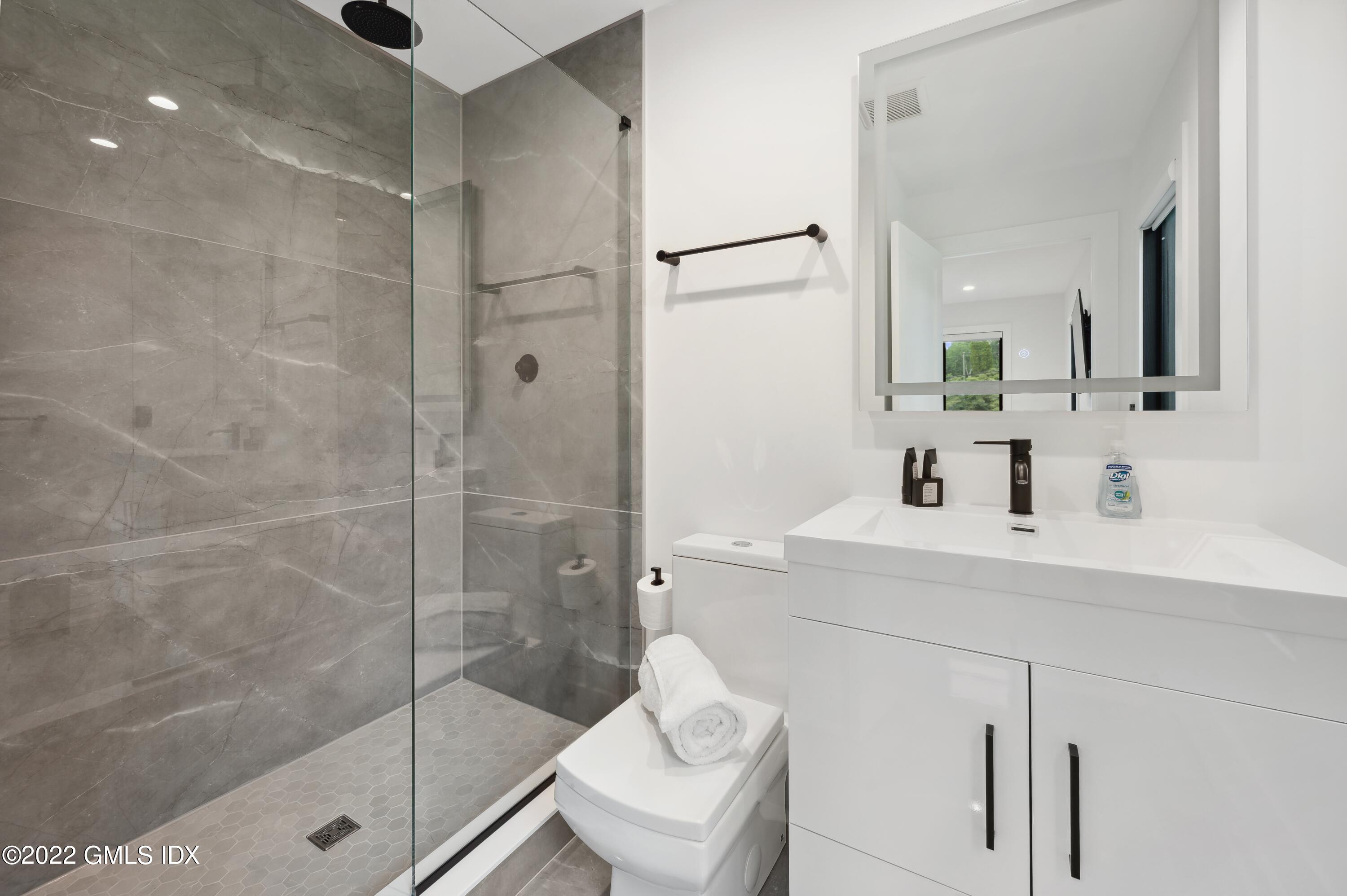 7 Drumlin Road Westport, CT 06880 - Photo 18 of 32 a bathroom with a shower sink mirror and toilet