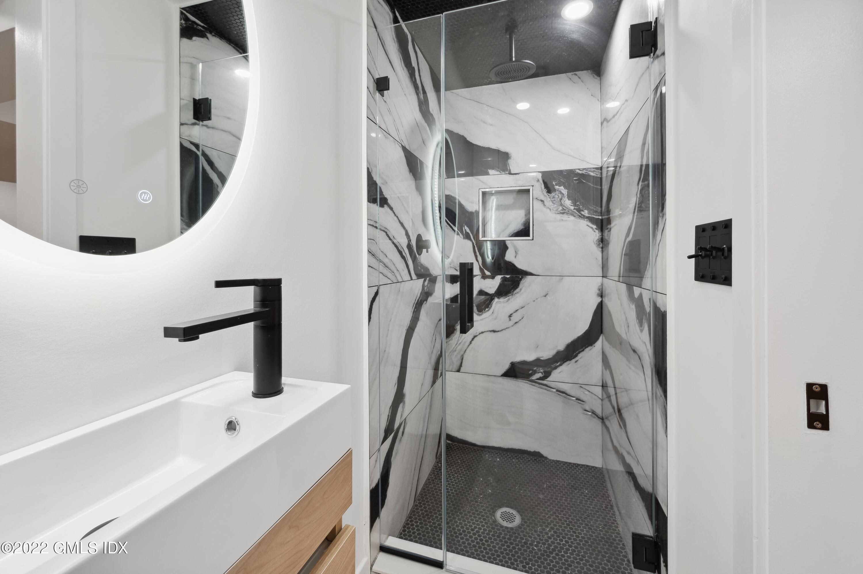 7 Drumlin Road Westport, CT 06880 - Photo 22 of 32 a bathroom with a sink and mirror