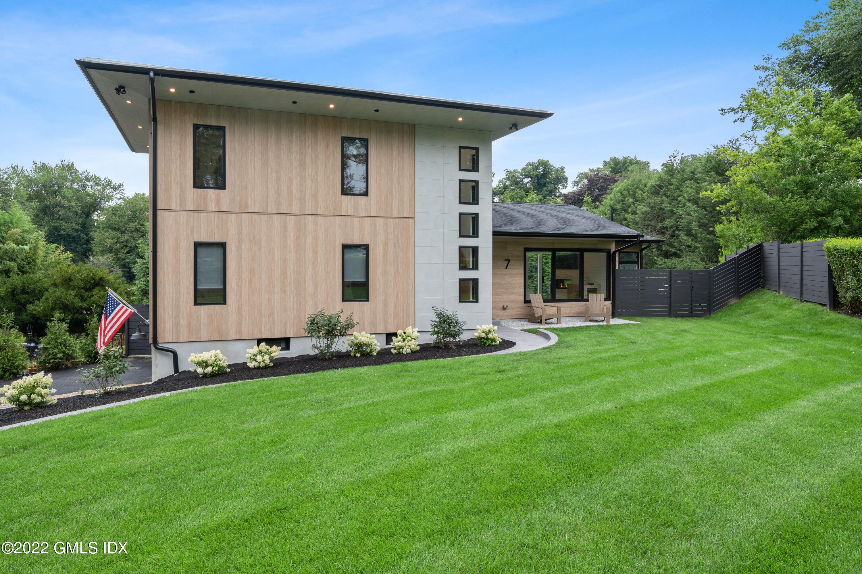 7 Drumlin Road Westport, CT 06880 - Photo 28 of 32 a front view of house with yard and green space