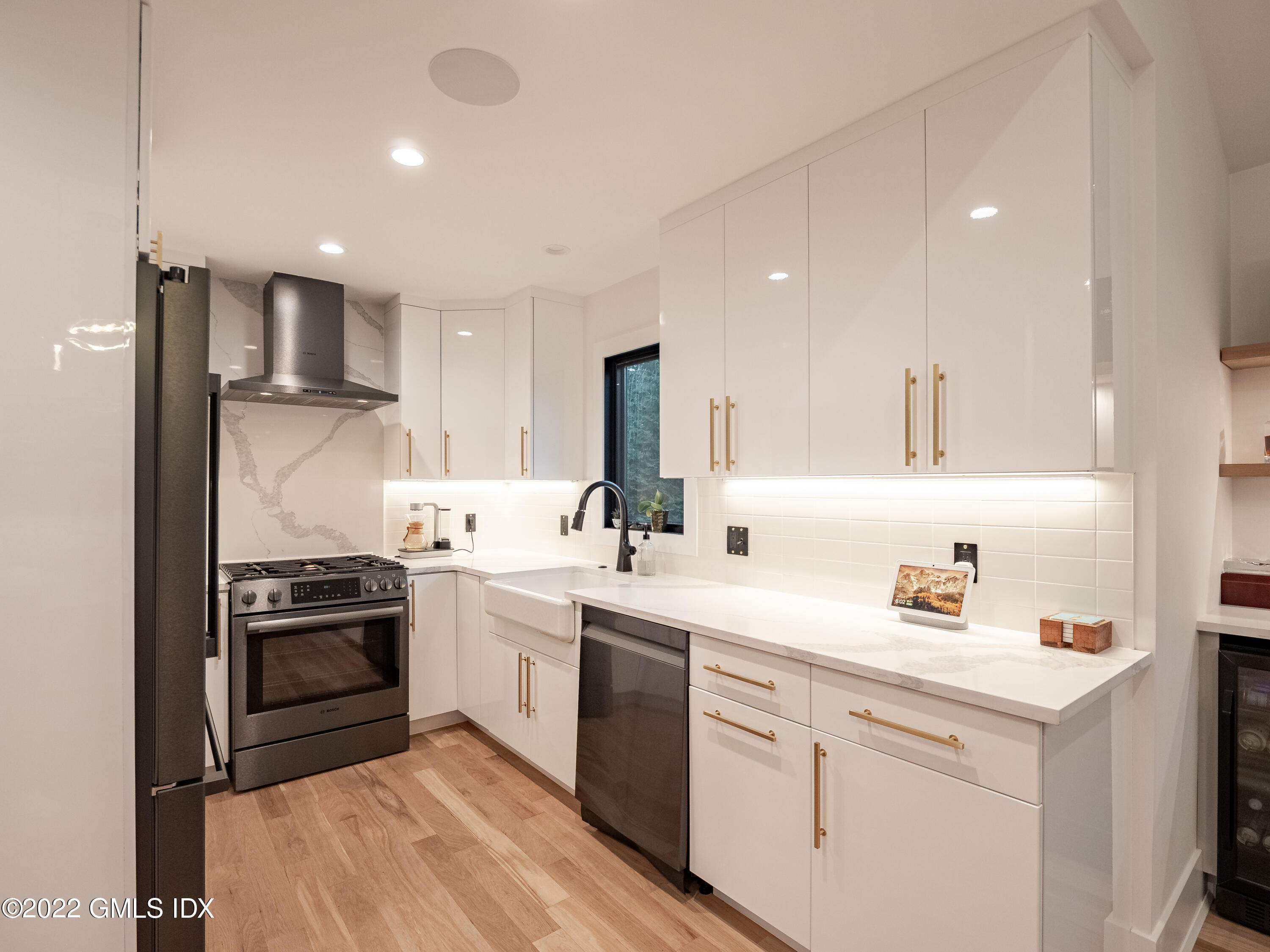 7 Drumlin Road Westport, CT 06880 - Photo 8 of 32 a kitchen with white cabinets and stainless steel appliances