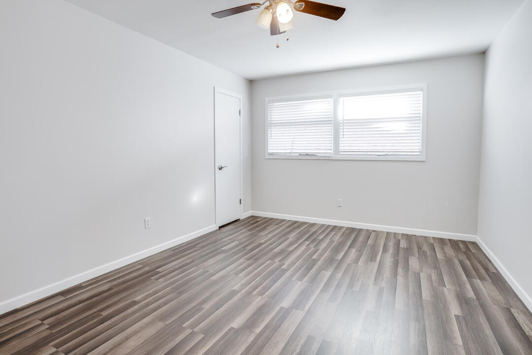 2123 66th Street Lubbock, TX 79412 - Photo 12 of 16 wooden floor in an empty room with a window