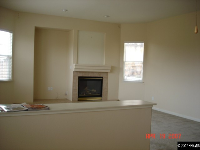 6801 Windy Hill Way Reno, NV 89519 - Photo 3 of 8 a living room with fireplace furniture and a window