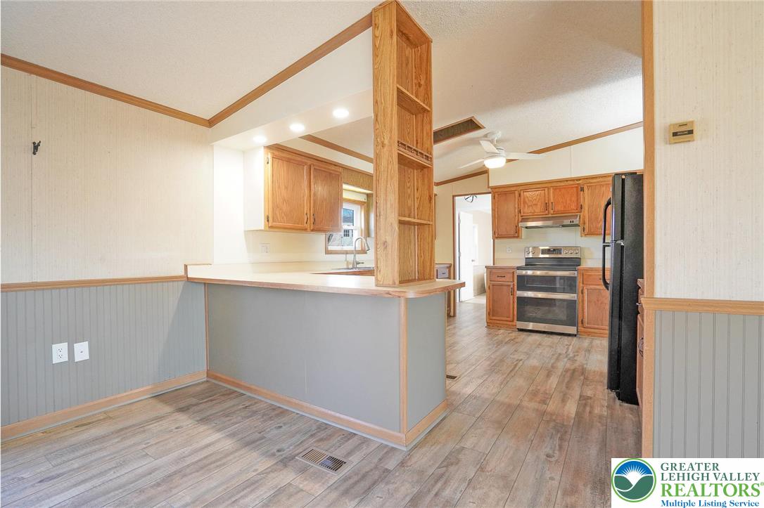 7221 Borman Road New Tripoli, PA 18066 - Photo 17 of 62 a kitchen with granite countertop a refrigerator and a stove top oven