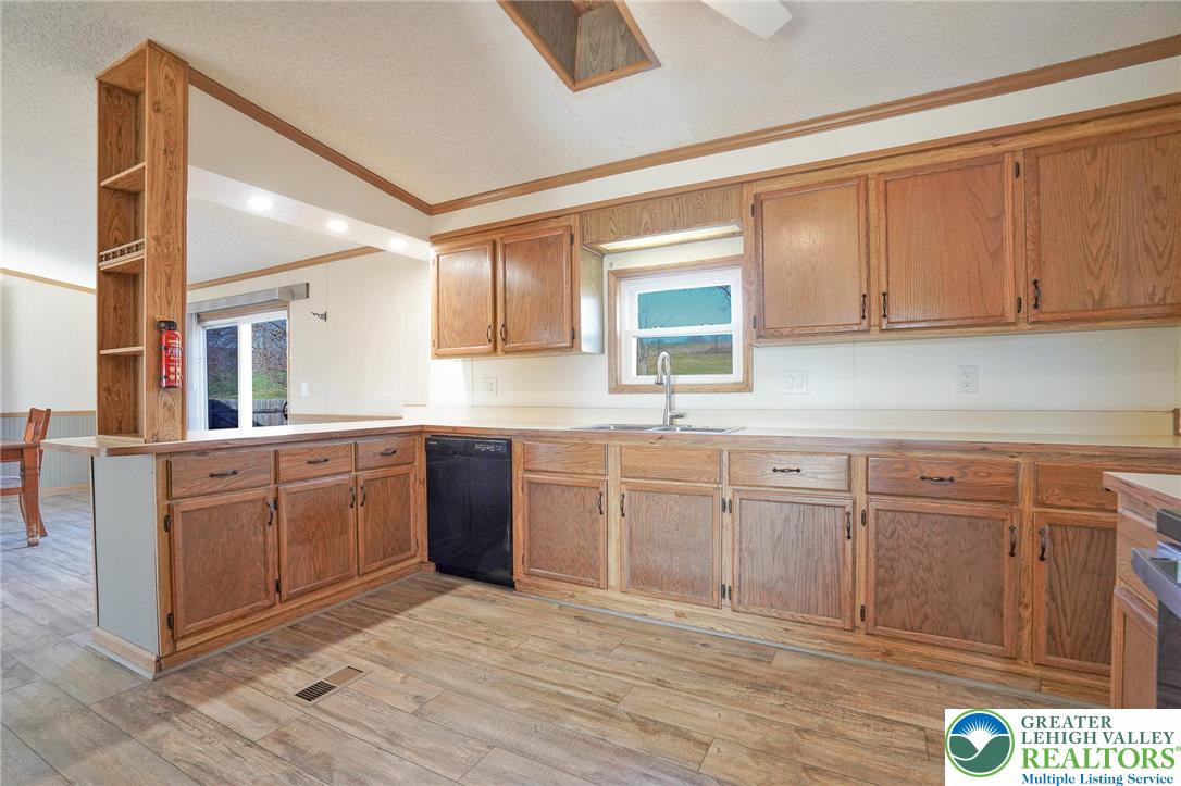 7221 Borman Road New Tripoli, PA 18066 - Photo 19 of 62 a kitchen with granite countertop a sink cabinets stainless steel appliances and a counter top space