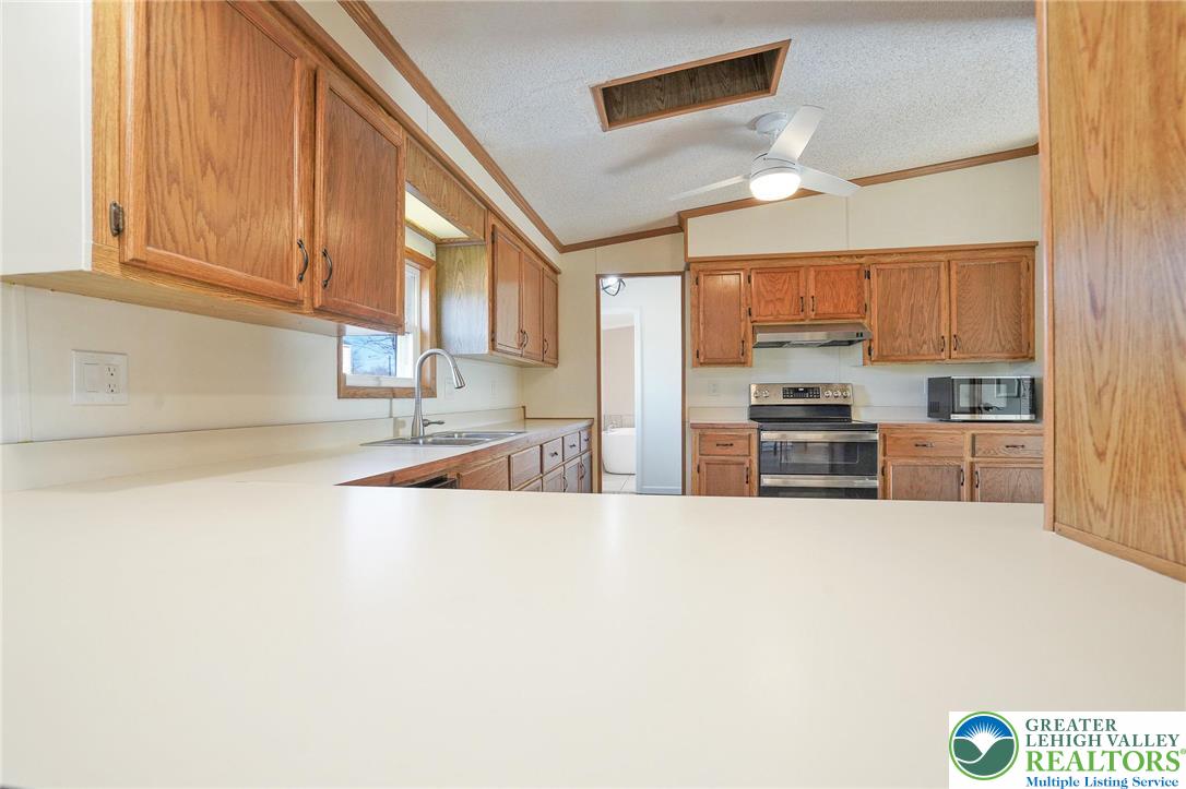 7221 Borman Road New Tripoli, PA 18066 - Photo 25 of 62 a kitchen with stainless steel appliances a refrigerator and a sink