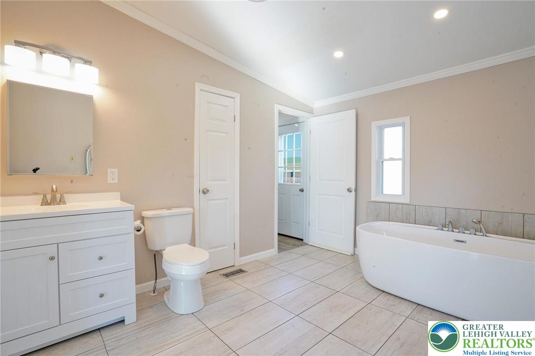 7221 Borman Road New Tripoli, PA 18066 - Photo 27 of 62 a spacious bathroom with a bathtub sink mirror and toilet
