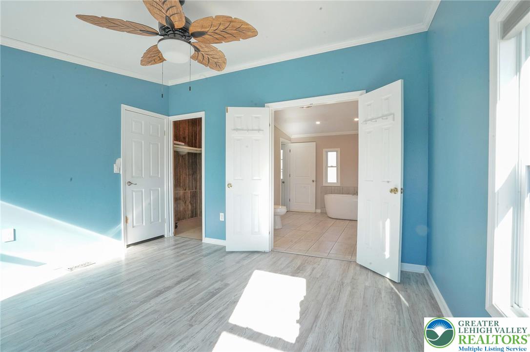 7221 Borman Road New Tripoli, PA 18066 - Photo 33 of 62 a view of a hallway with wooden floor and a chandelier fan
