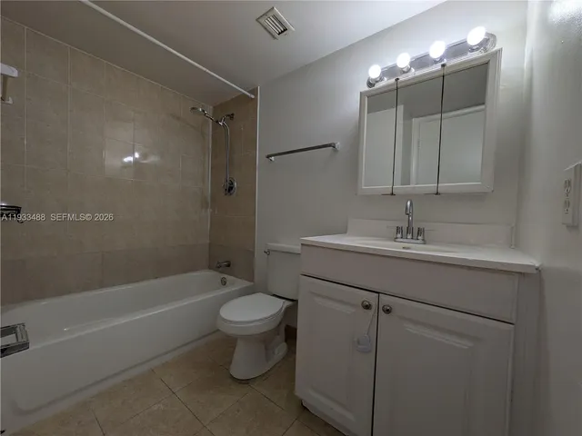 a bathroom with a sink toilet a mirror and shower