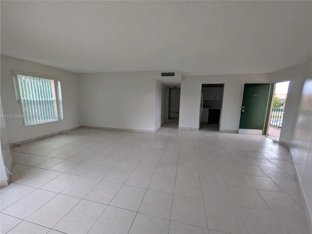 an empty room with windows and entrance