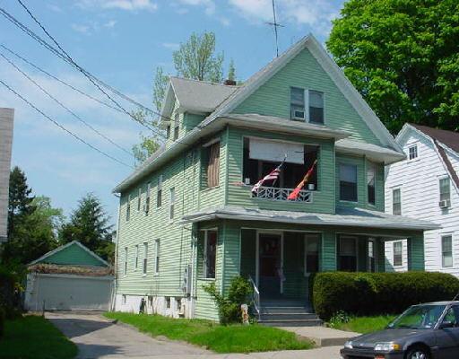 142 Thorme Street Bridgeport, CT 06606 - Photo 1 of 1 a view of a white house with large windows and a yard