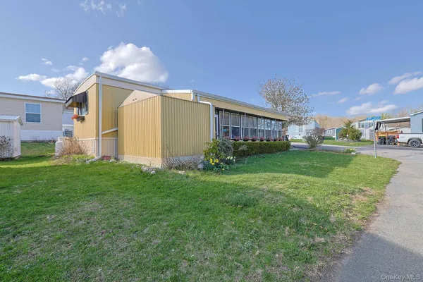 a view of a house with backyard and sitting area