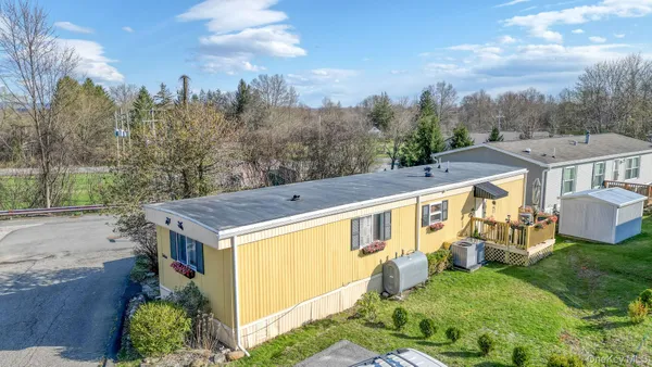 an aerial view of a house with a yard
