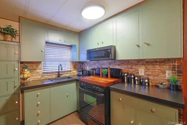 a kitchen with stainless steel appliances granite countertop a sink and cabinets