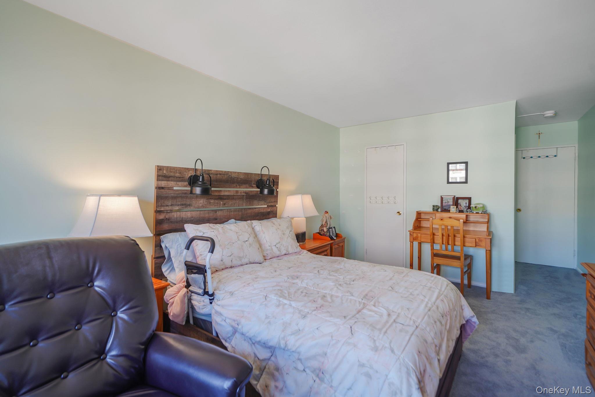 450 Shore Road, Unit 8G Long Beach, NY 11561 - Photo 12 of 19 a bedroom with a bed and a couch