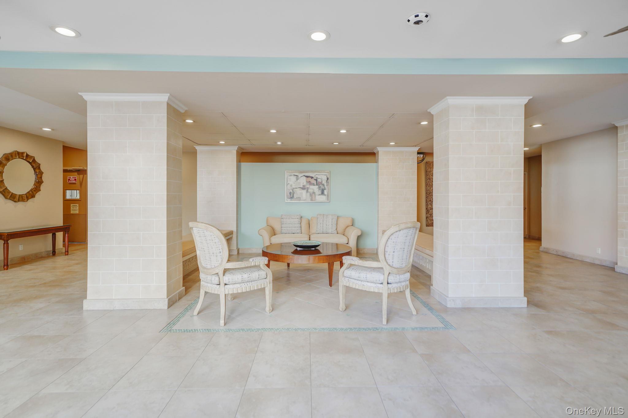 450 Shore Road, Unit 8G Long Beach, NY 11561 - Photo 17 of 19 a living room with furniture and a table