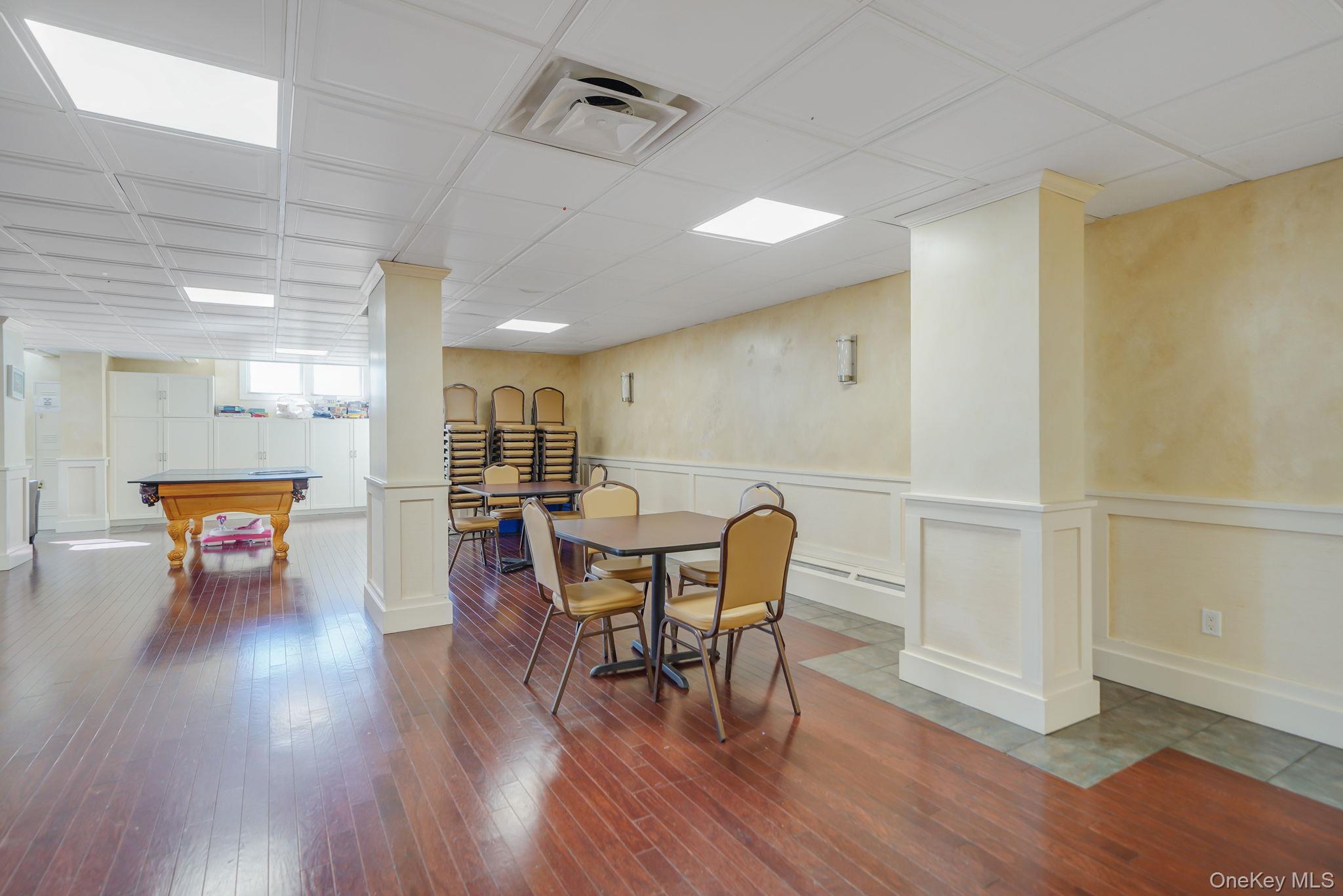 450 Shore Road, Unit 8G Long Beach, NY 11561 - Photo 18 of 19 a view of a dining room with furniture and wooden floor