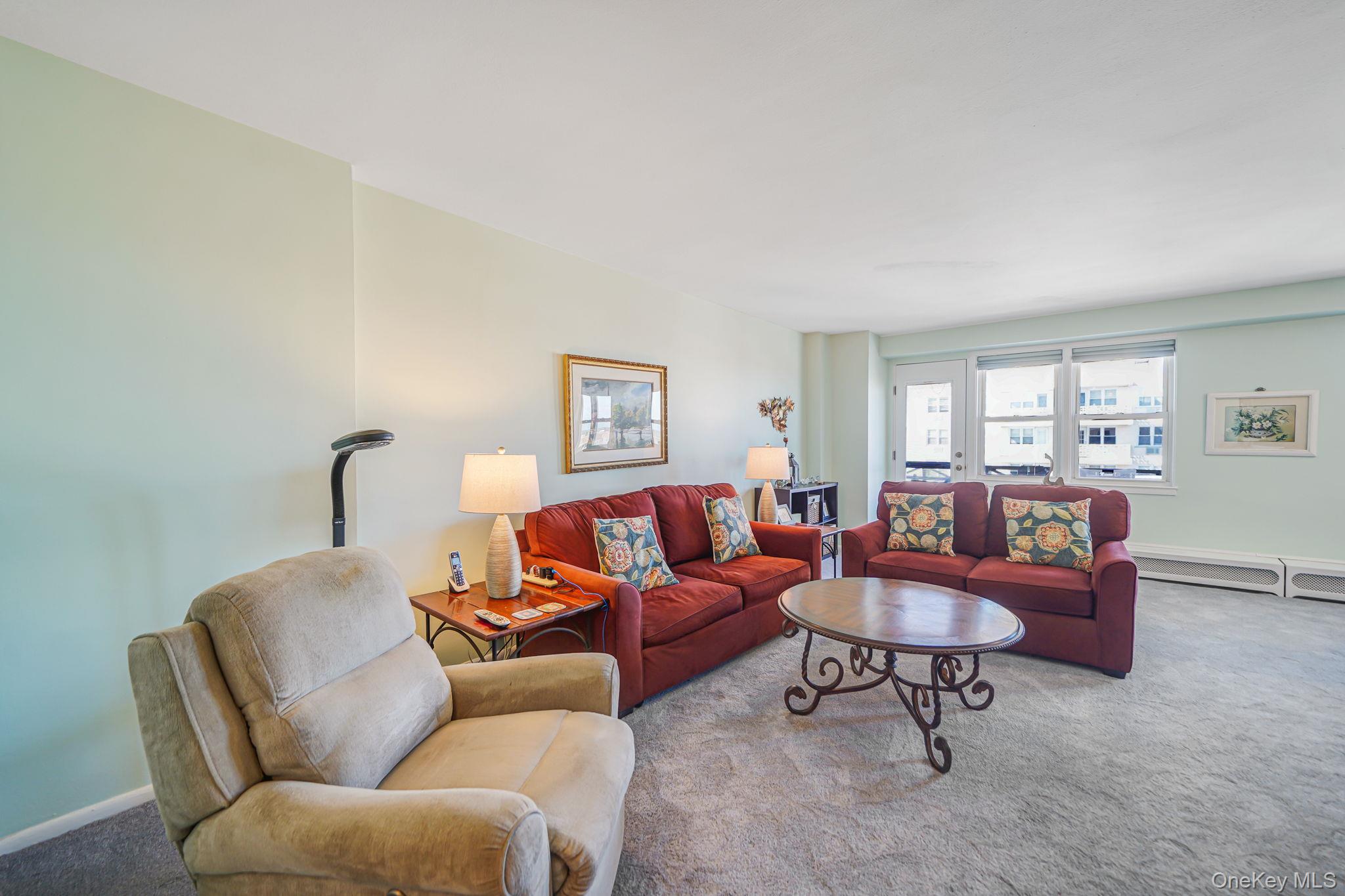 450 Shore Road, Unit 8G Long Beach, NY 11561 - Photo 5 of 19 a living room with furniture and a window
