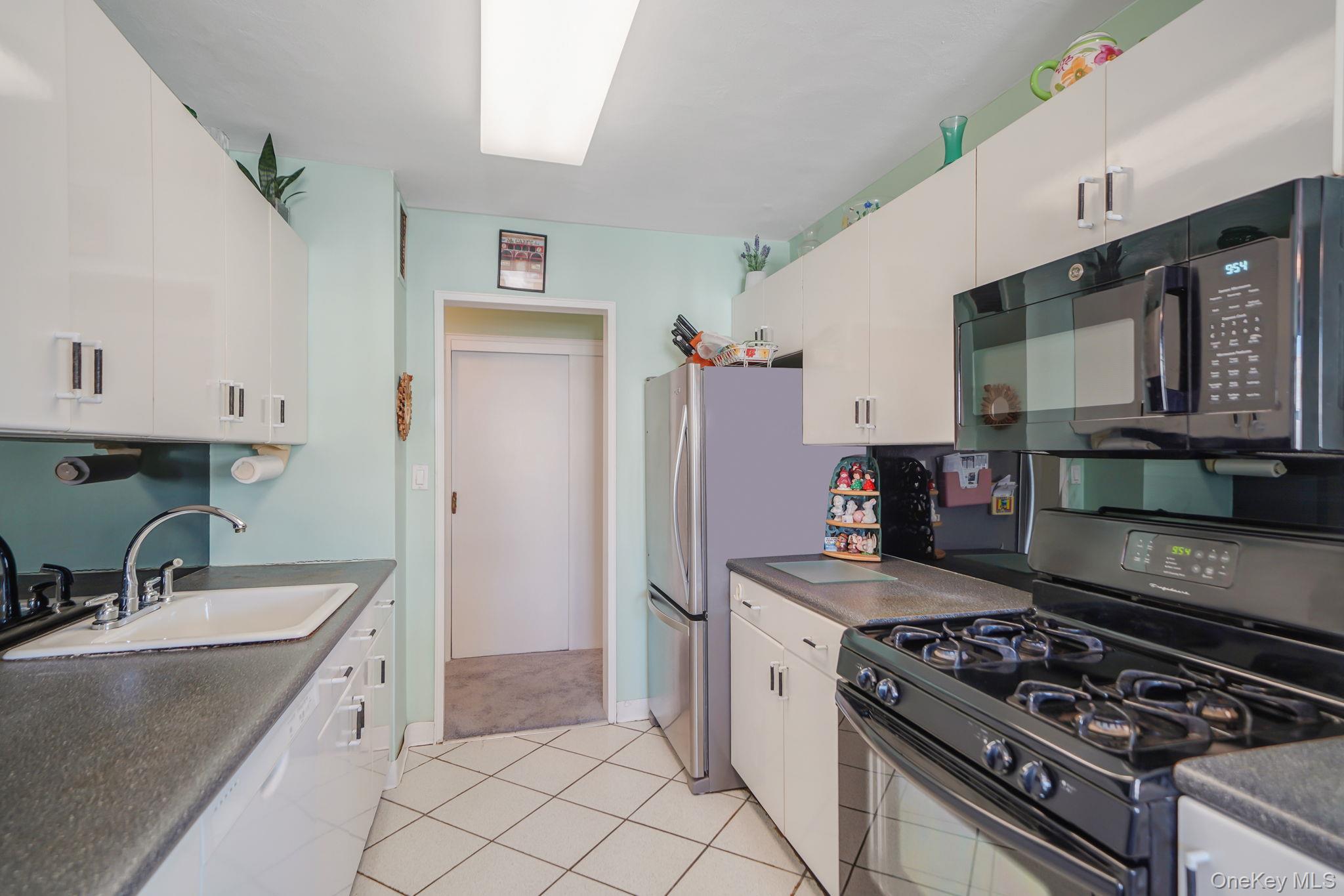 450 Shore Road, Unit 8G Long Beach, NY 11561 - Photo 10 of 19 a kitchen with a stove and a sink