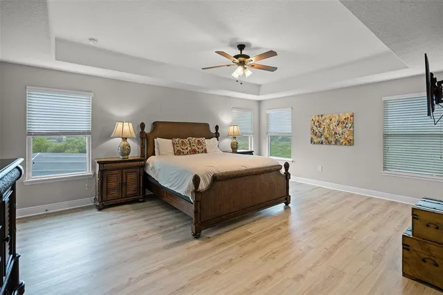 a bedroom with a bed chandelier and a window
