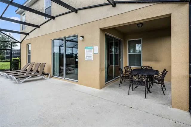 a view of a patio with table and chairs and potted plants