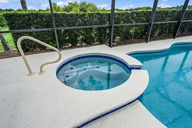 a view of a couches in a patio with a swimming pool