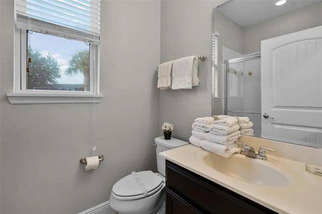 a bathroom with a sink toilet and mirror