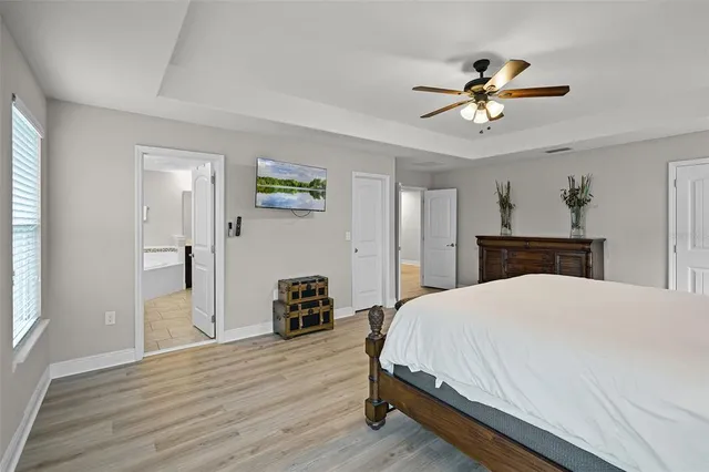 a bedroom with a bed and a chandelier