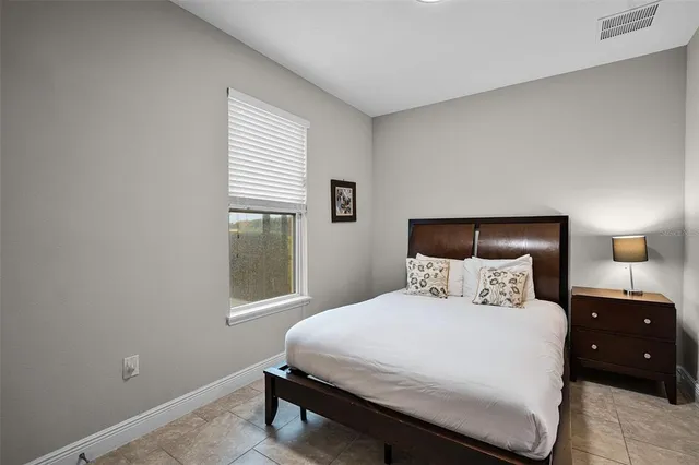 a bedroom with a bed and a lamp