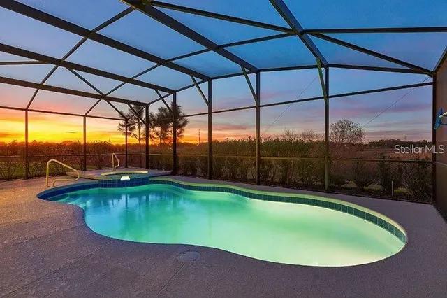 a view of a swimming pool with a yard