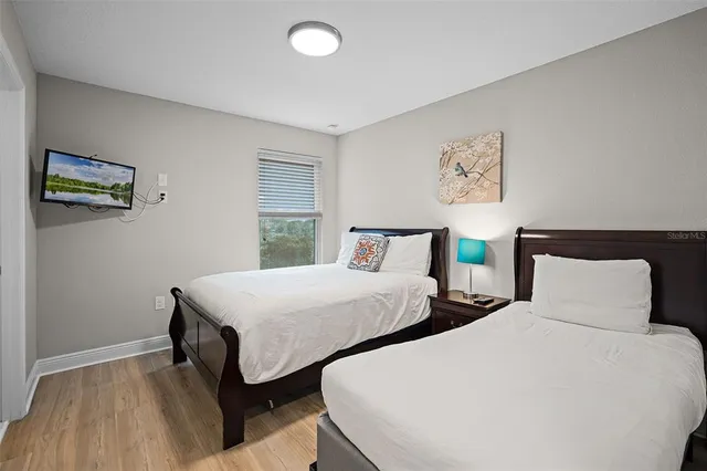 a bedroom with two beds and a window