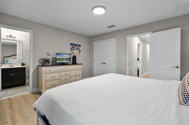 a bedroom with a bed and a dresser