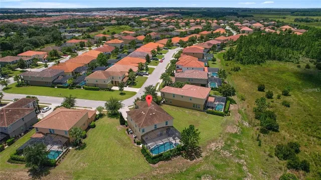 an aerial view of a house with a garden and lake view