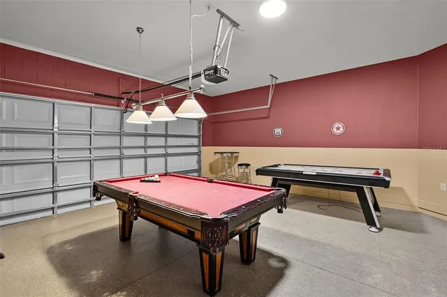 a room with pool table and windows