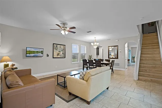 a living room with furniture and a chandelier