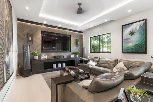 a living room with furniture potted plant and a flat screen tv