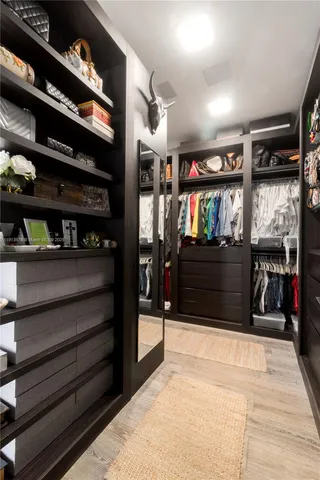 a bedroom with a bed and painting on the wall