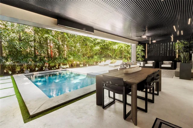 a kitchen with a table chairs and refrigerator