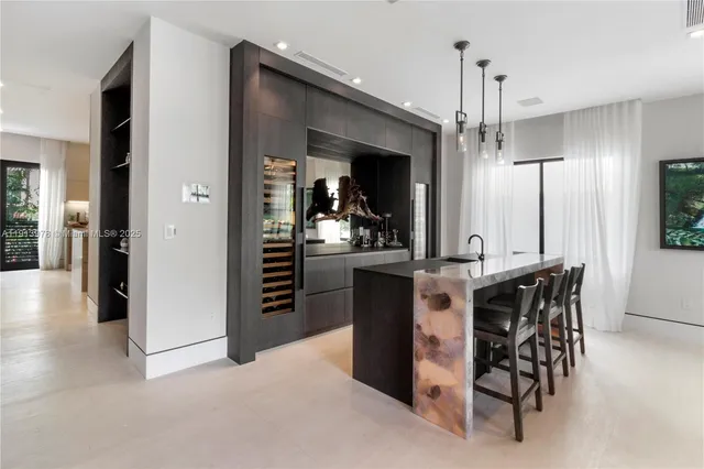 a kitchen with a dining table chairs and a potted plant