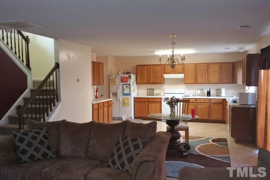 5956 Ricker Road Raleigh, NC 27610 - Photo 3 of 13 a living room with lots of furniture and kitchen view