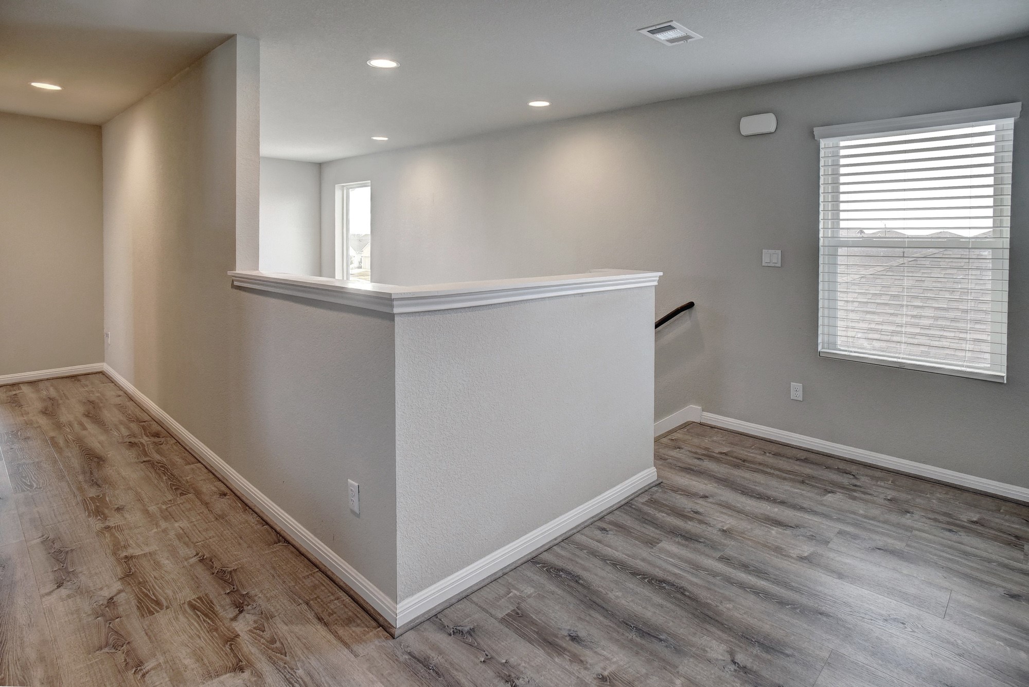 210 Cold Spg Loop Bastrop, TX 78602 - Photo 21 of 40 Corridor featuring an upstairs landing, light wood-style floors, and recessed lighting