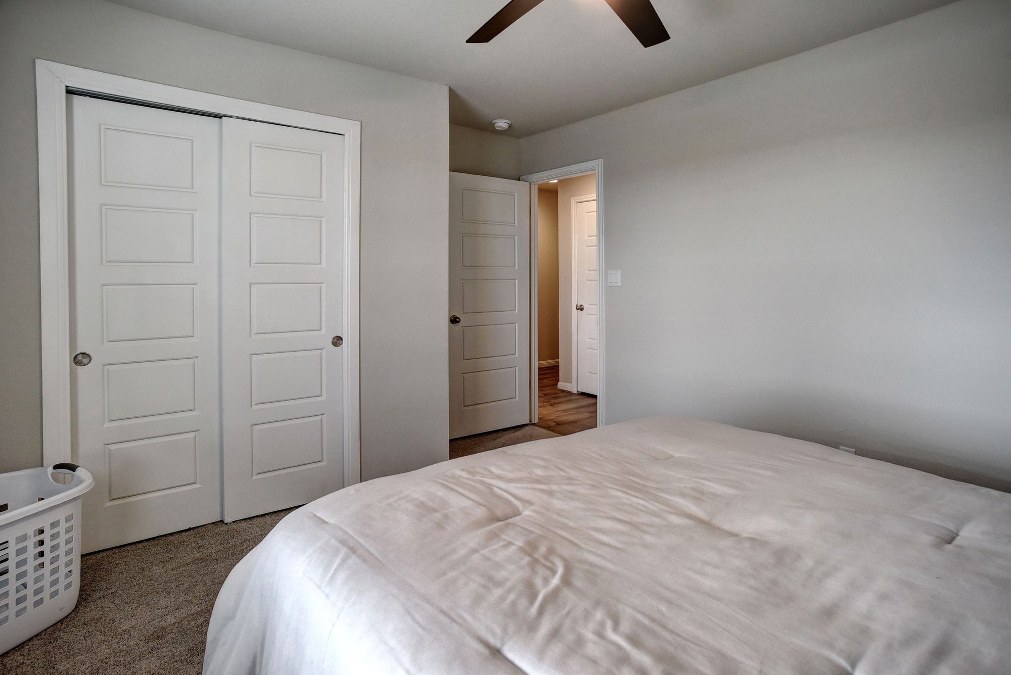 210 Cold Spg Loop Bastrop, TX 78602 - Photo 31 of 40 Bedroom with dark colored carpet, a closet, and ceiling fan