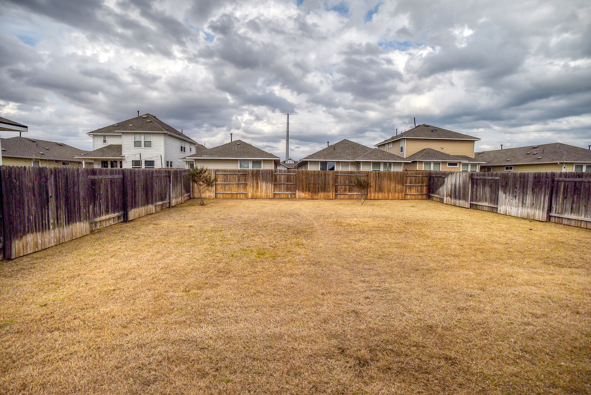 210 Cold Spg Loop Bastrop, TX 78602 - Photo 40 of 40 Fenced backyard featuring a residential view