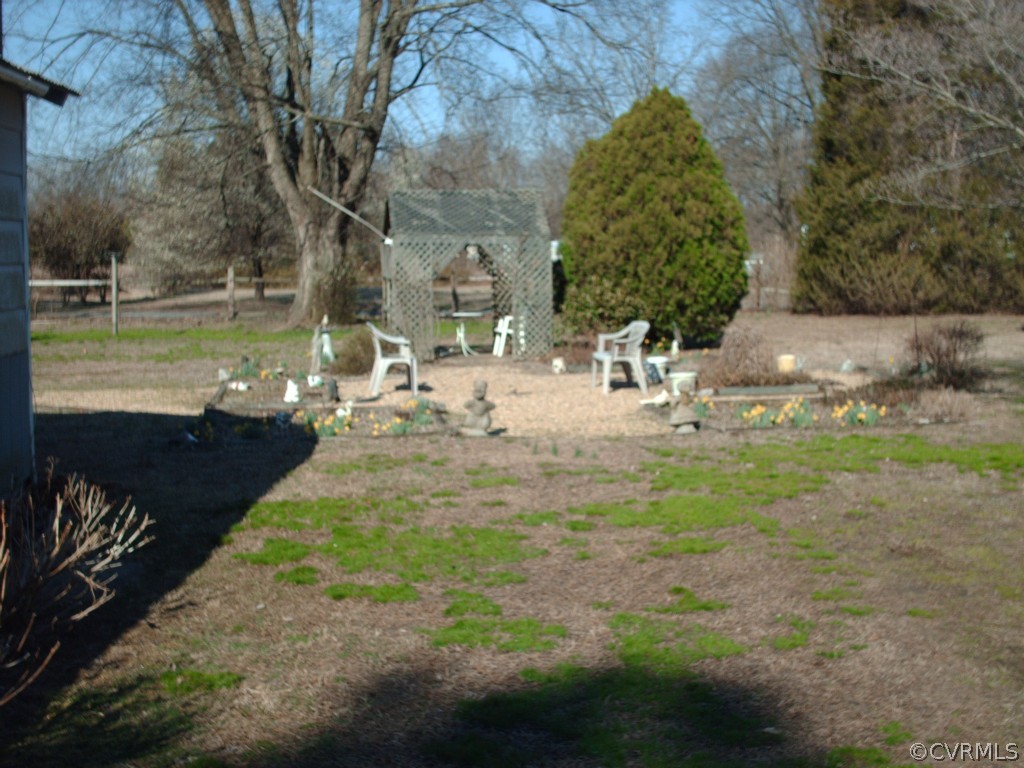 1521 Point Of Rocks Road Chester, VA 23836 - Photo 5 of 12 a view of a yard with table and chairs