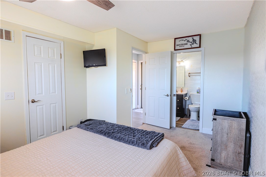 1436 Cherokee Road, Unit 2B Lake Ozark, MO 65049 - Photo 11 of 30 Downstairs Bed with En-Suite