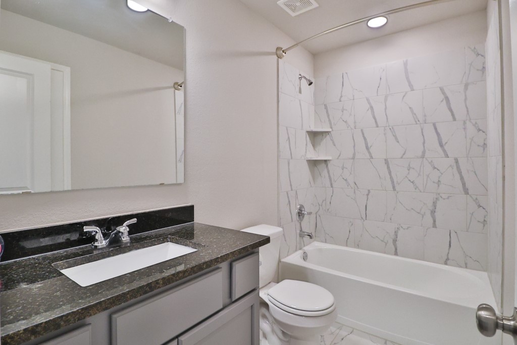 1926 Viva Road Bryan, TX 77807 - Photo 29 of 39 a bathroom with a granite countertop sink toilet and shower